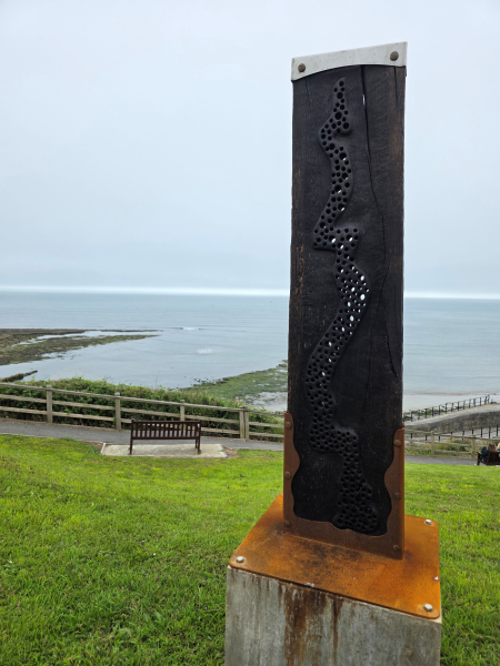 new sculpture carved in oak and charred black, with metal work that will rust orange